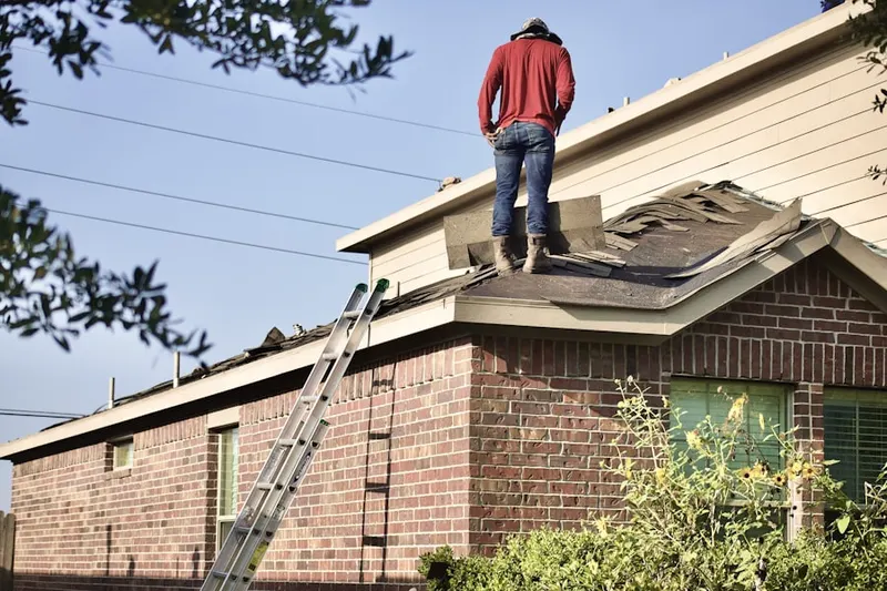 Professional roofer working on a residential roof in Derwood